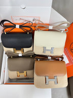 Hermes small crossbody bags in black, cream, taupe, and tan with H buckle hardware