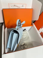 Blue Hermes bag with leather strap and gold hardware, open gift box