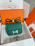 Green leather crossbody handbag with front flap and silver H clasp detail