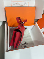 Hermes red leather crossbody bag, open side view with strap