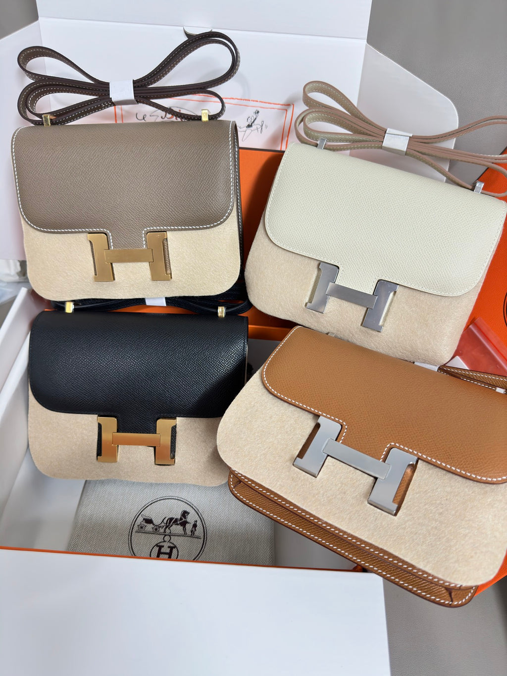 Mini leather bags in multiple colors with gold H-front clasps, shown together