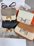 Mini leather bags in multiple colors with gold H-front clasps, shown together