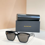 Square sunglasses with black frames and gray-tinted lenses