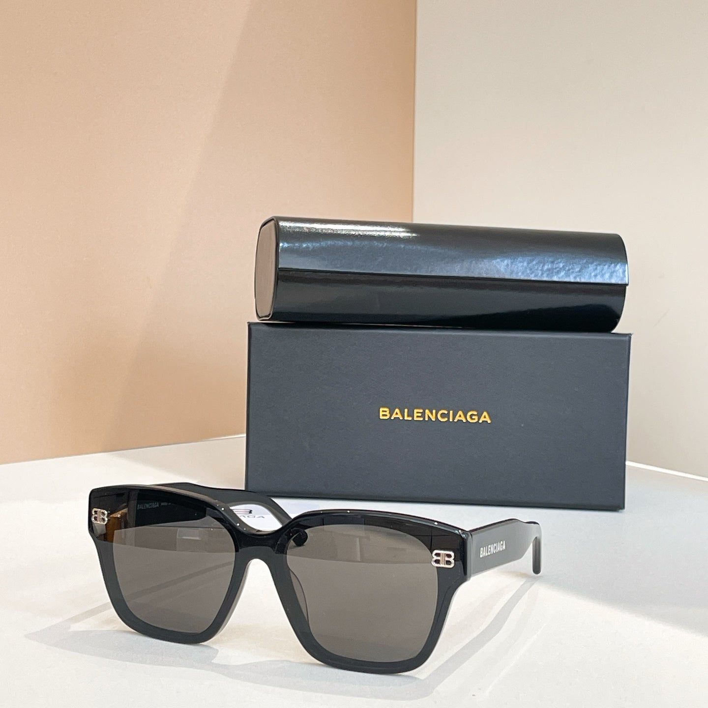 Square sunglasses with black frames and gray-tinted lenses