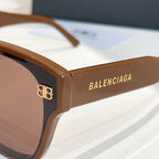 Close-up of square sunglasses frame with tan arms and logo detail