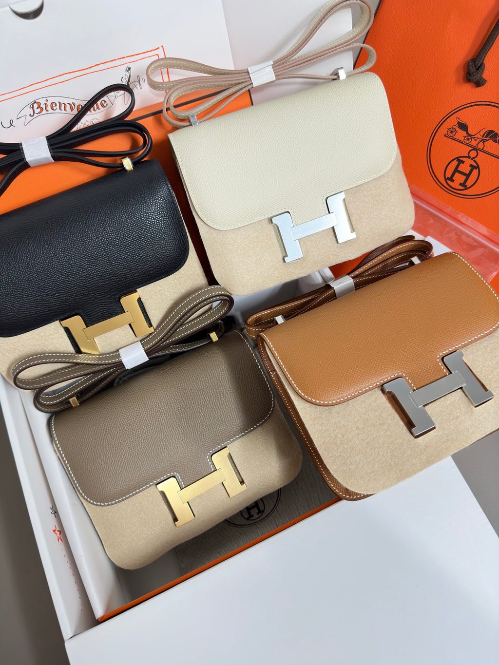 Hermes crossbody bags close-up with cream, black, taupe, and tan flap designs
