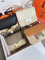 Hermes crossbody bags close-up with cream, black, taupe, and tan flap designs