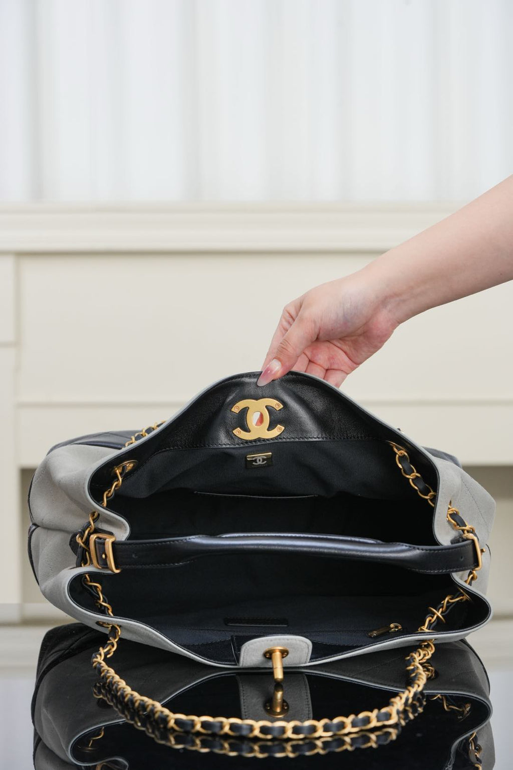 Chanel quilted handbag with chain strap, black interior view and gold hardware