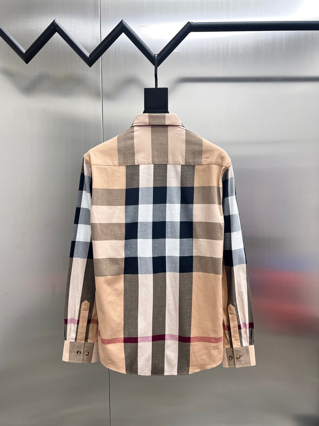 Back view of long-sleeve button-up shirt with beige and navy plaid check