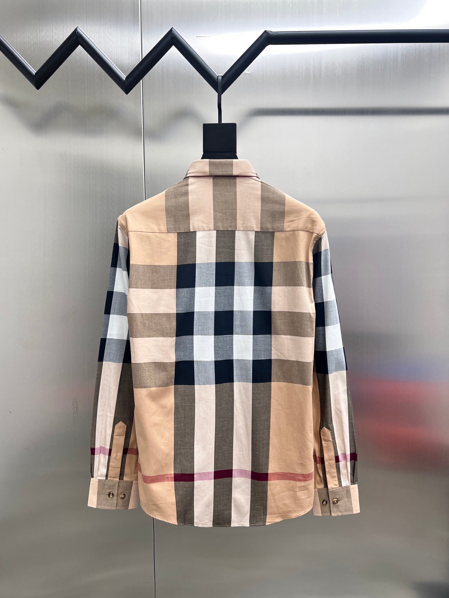 Back view of long-sleeve button-up shirt with beige and navy plaid check