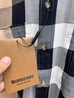 Collar and placket close-up on Burberry plaid button-up shirt with tags