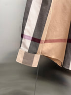 Hem and lower side of plaid long-sleeve button-up shirt with color blocks
