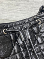 Dior black leather strap detail with metal grommets and stitched quilting