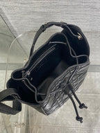 Dior black quilted leather bag open, showing interior and drawstring tie
