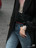 Chanel black quilted clutch with CC clasp and silver-tone CC cuff bracelet