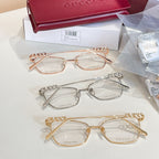 Gucci eyeglass frames set with rose-gold, silver, and gold-tone oval lenses.
