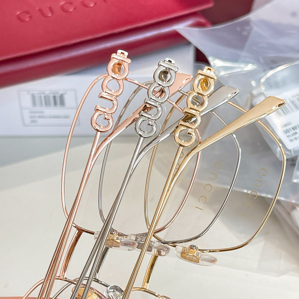 Gucci eyeglass frames set with gold, rose-gold, and silver-tone metal rims.
