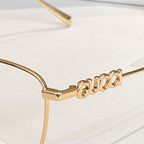 Gucci eyeglass temple with gold metal 'Gucci' lettering detail.