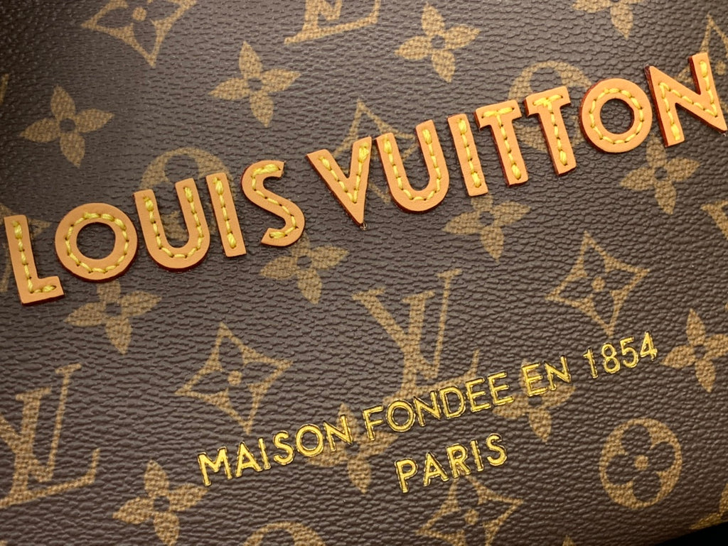Louis Vuitton monogram canvas bag close-up with gold lettering and repeating pattern