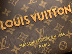 Louis Vuitton monogram canvas bag close-up with gold lettering and repeating pattern