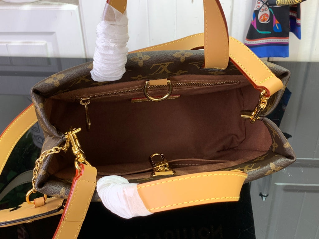 Monogram tote bag open top showing tan lining, inner zip pocket, and gold hardware