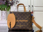Monogram tote bag with tan leather trim, top handles, and front oval patch pocket