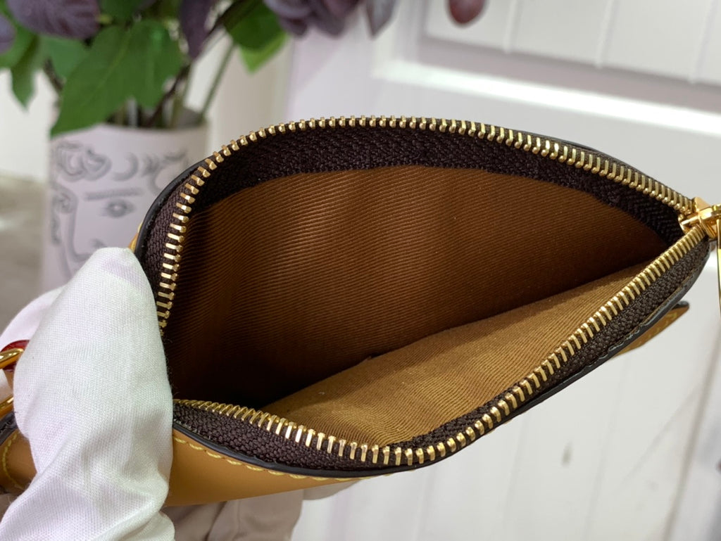 Monogram tote bag interior with tan lining and gold-tone zipper trim, open top