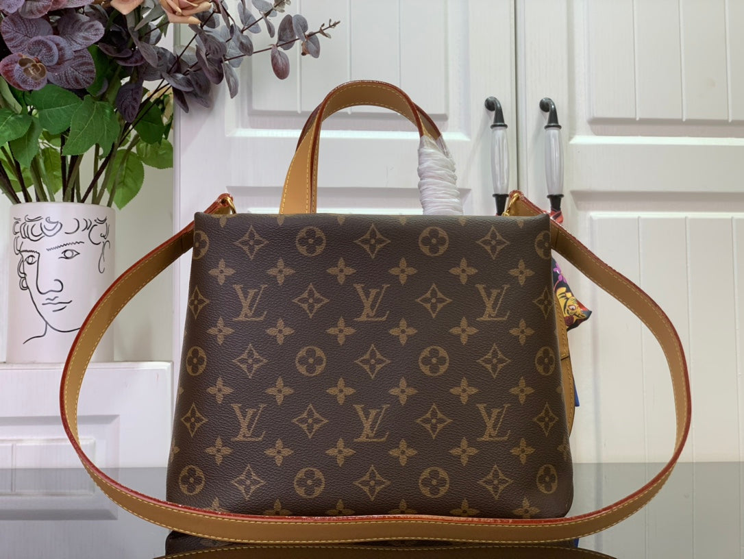 Monogram tote bag with tan leather handles and long shoulder strap, front view