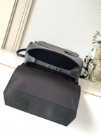 Men's Louis Vuitton bag top view with snap flap and short handle, dark leather-look.