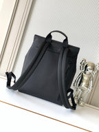 Men's Louis Vuitton bag from side angle, top handle and adjustable shoulder strap, dark.