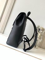 Men's Louis Vuitton bag upright view with top handle and wide shoulder strap, dark.