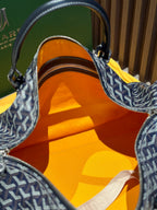 Goyard duffel bag open top showing orange fabric lining and zipper track