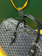 Goyard duffel bag side view with navy patterned canvas and top zip closure