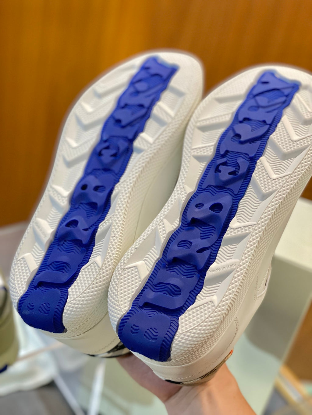 Sneaker insoles with bold blue patterned graphic underfoot