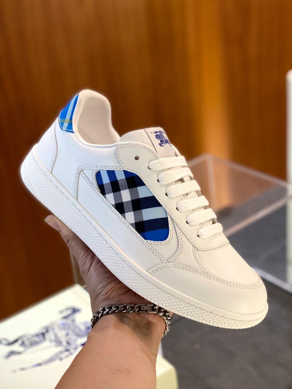 White sneaker with blue check quarter panel, lace-up front and blue logo detail