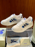White leather low-top sneakers with blue check side panel and lace-up closure