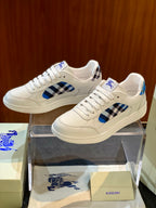White leather low-top sneakers with blue check side panel and lace-up closure