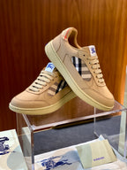 Beige sneakers with check detail, lace-up design and blue logo patch on tongue