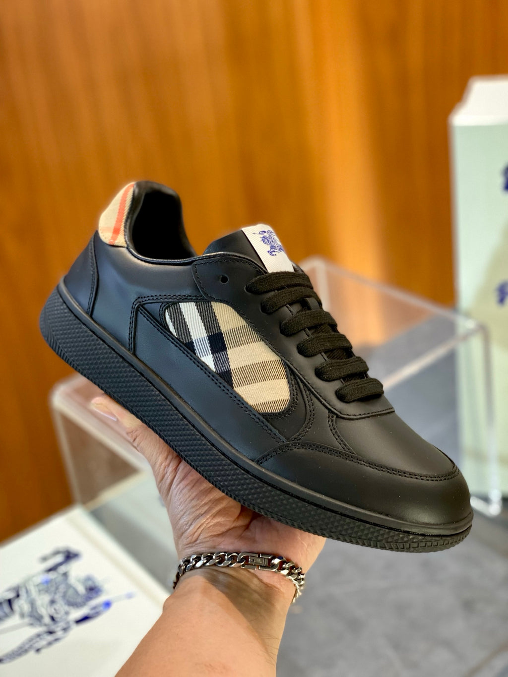 Dark green low-top sneaker with plaid side panel and lace-up, orange trim at collar