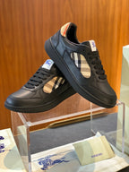 Dark leather low-top sneakers with plaid side panel and lace-up, angled view