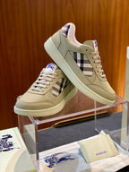 Beige low-top sneaker with plaid side panel and lace-up, shown at an angle