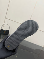 Fendi slide sandal outsole, textured rubber tread with small logo marking.