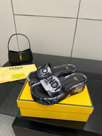 Fendi slide sandals with printed 'FENDI' strap and flat slip-on sole.