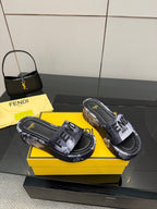 Fendi logo slide sandals in black with gray patterned strap and cushioned footbed.