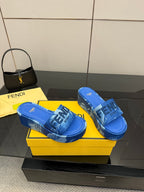 Fendi women's blue slide sandals, side view with FF logo strap detail.