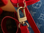 Red leather strap with gold clasp and Louis Vuitton logo on denim bag