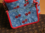 Denim crossbody bag with cherry print, red trim and top zipper