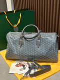 Grey patterned duffel bag with top handles and zip closure, leather trim