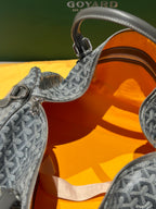Duffel bag interior with orange lining and grey patterned trim near zipper