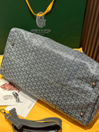 Grey patterned large duffel bag with zip top and detachable shoulder strap